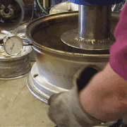 The alloy wheel repair is checked with a micrometer (pronounced: my-crom-it-ter) to insure the accuracy of the repair.